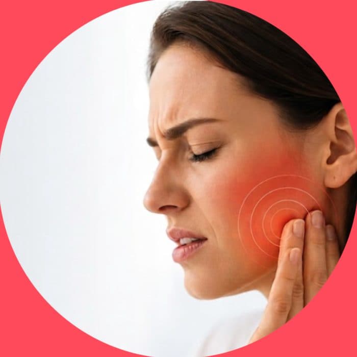 Woman holding her jaw in pain