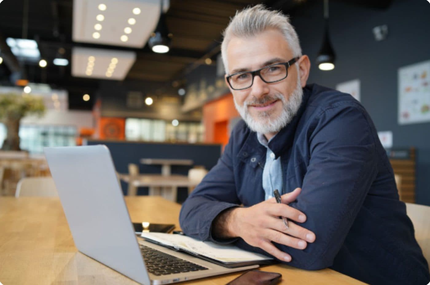 Man smiling while working on a laptop