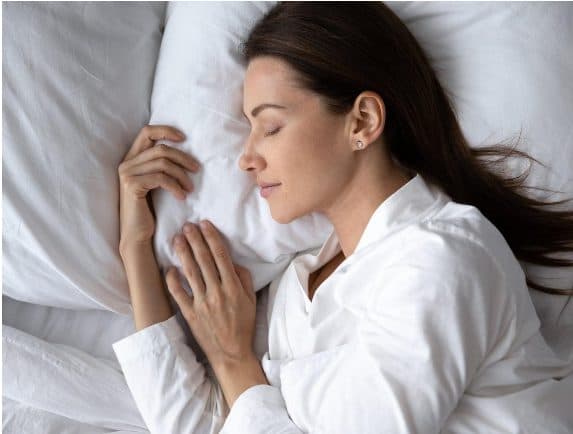 Woman sleeping on a white pillow